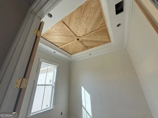 a view of staircase with railing and white walls