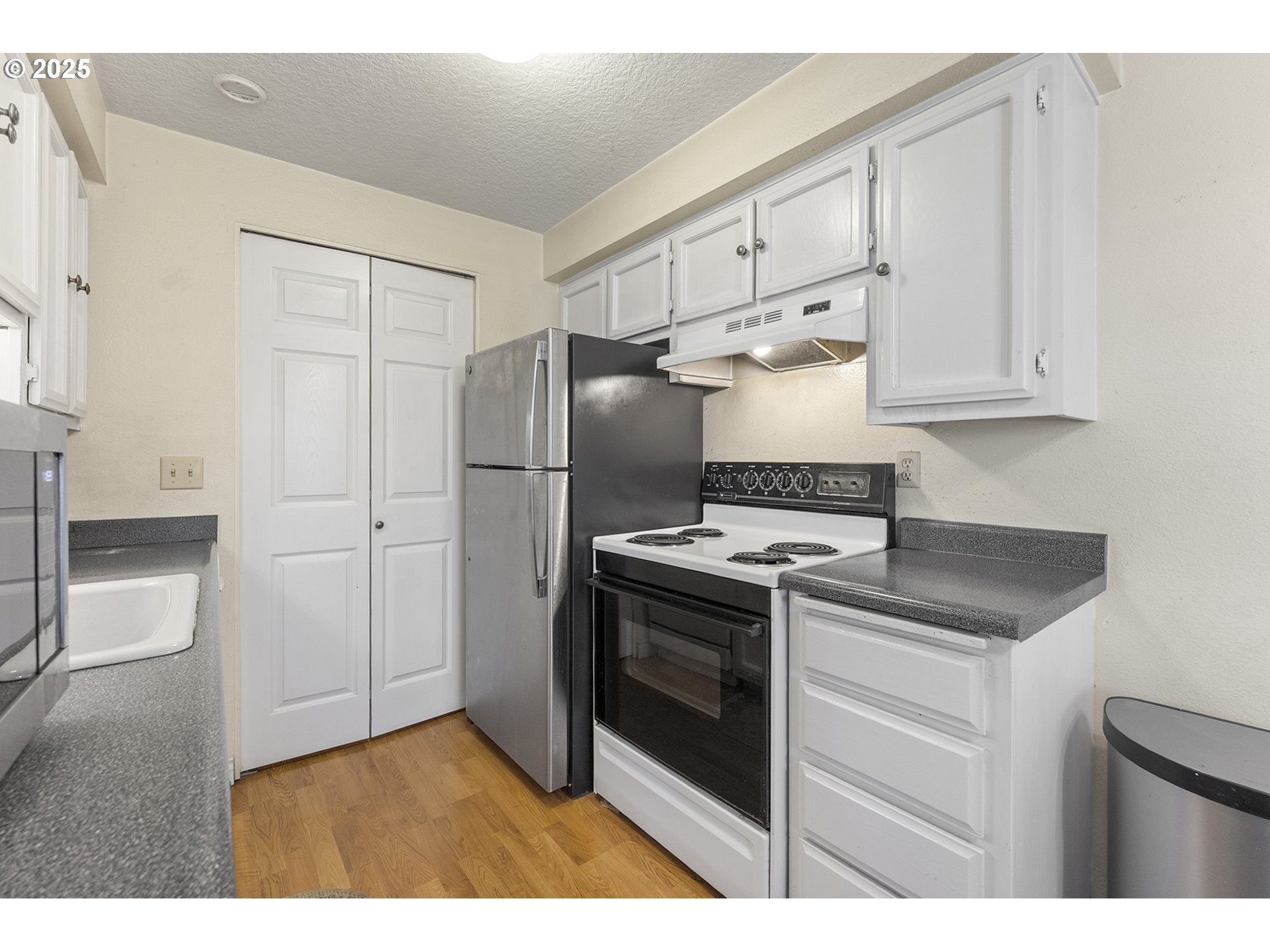 8512 Southwest Mohawk Street Tualatin, OR 97062 - Photo 13 of 33 a kitchen with stainless steel appliances granite countertop a refrigerator and a stove
