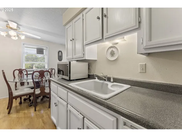 a living room with granite countertop furniture and a sink