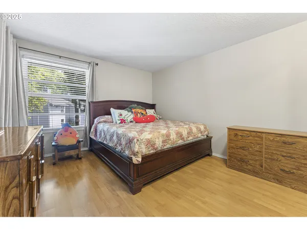 a bed sitting in a bedroom next to a window