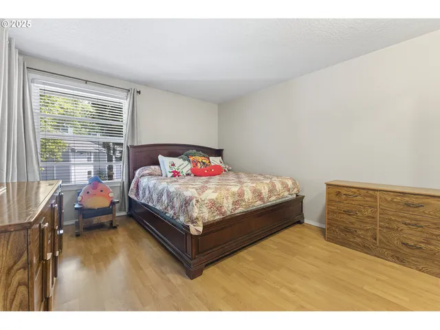 a bed sitting in a bedroom next to a window