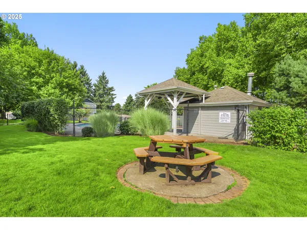 a view of a house with backyard sitting area and garden