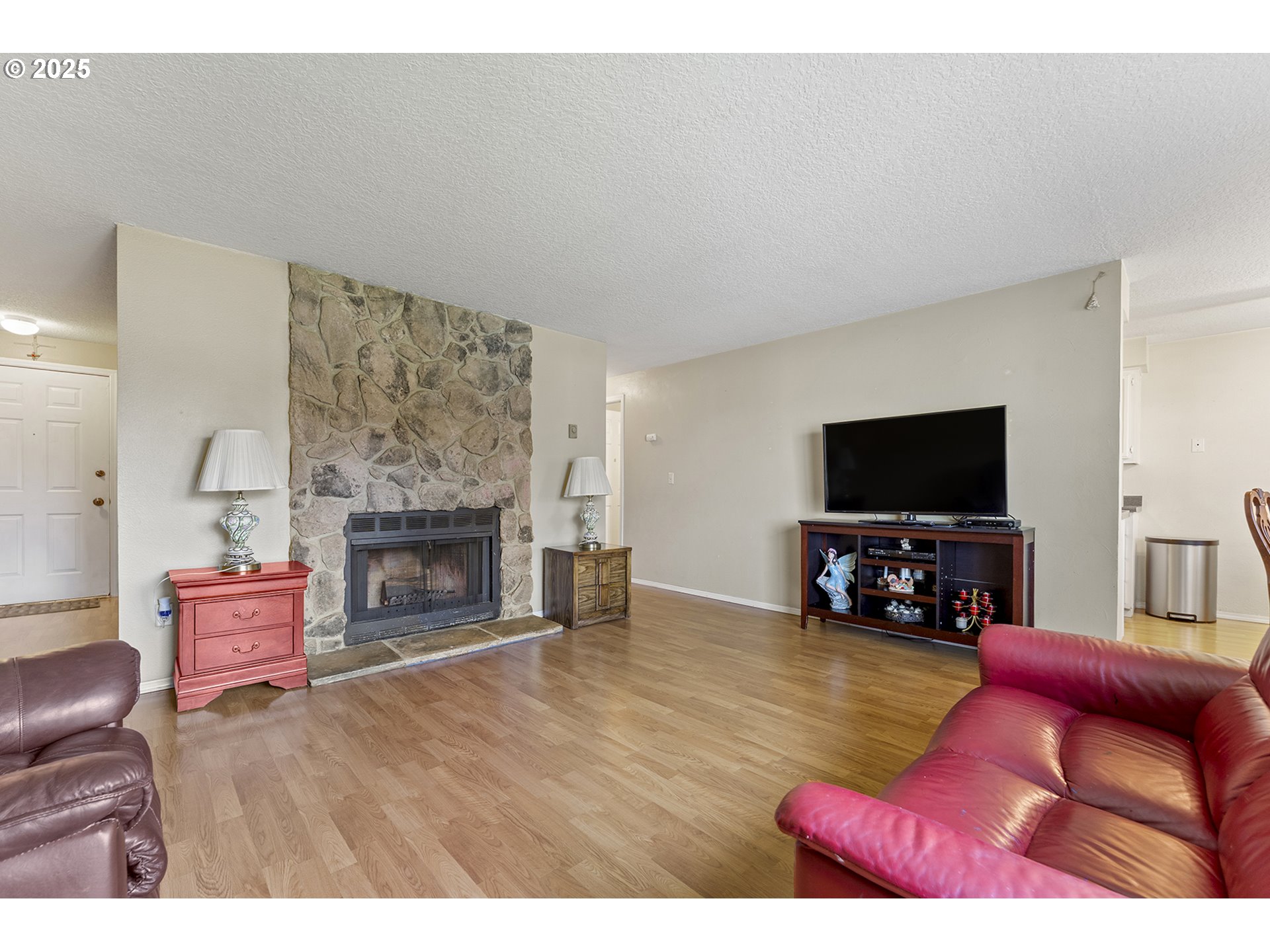8512 Southwest Mohawk Street Tualatin, OR 97062 - Photo 4 of 33 a living room with furniture a flat screen tv and a fireplace