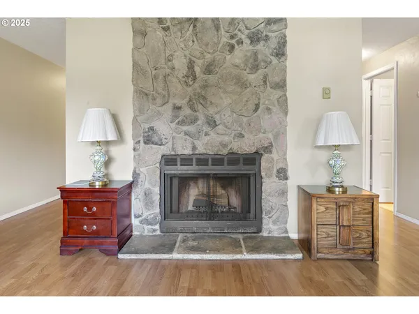 a living room with hard wood floors and a fireplace