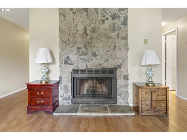 a living room with hard wood floors and a fireplace