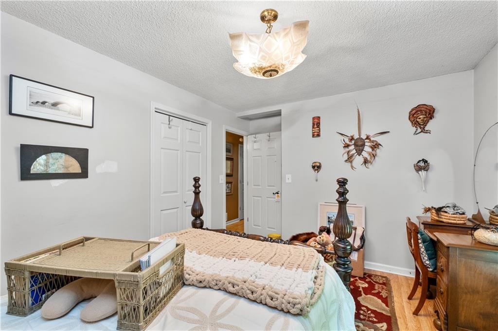 511 Oakdale Road Canton, GA 30114 - Photo 17 of 50 a bedroom with a bed and a chandelier