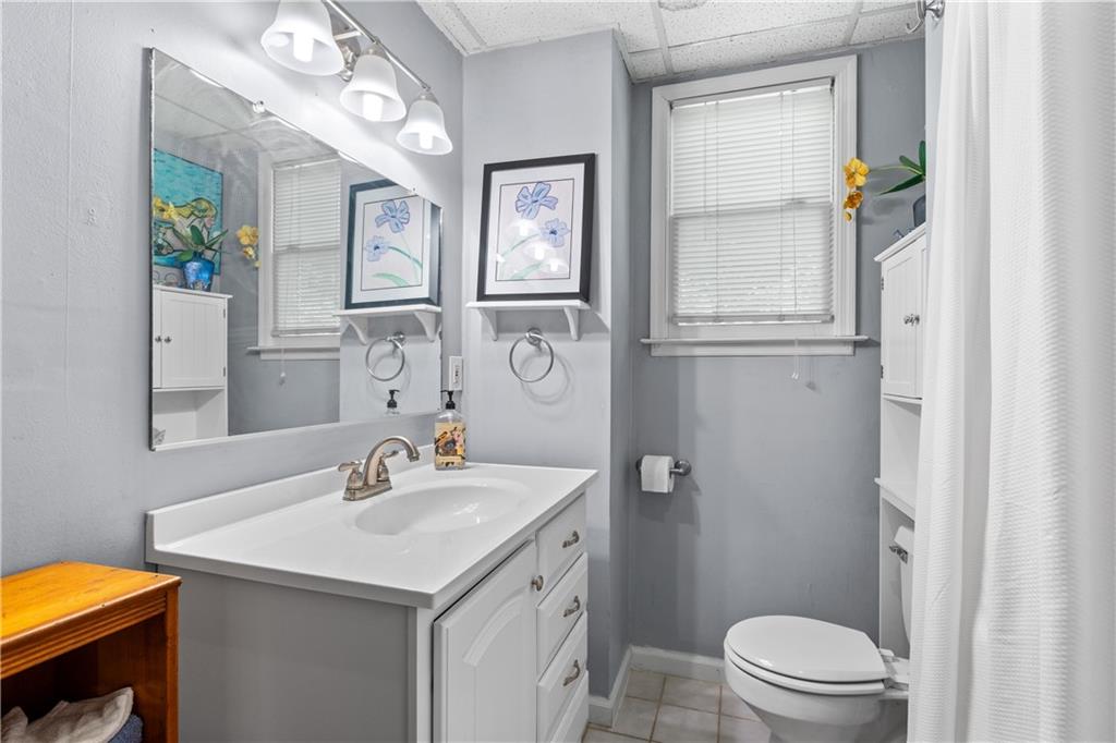 511 Oakdale Road Canton, GA 30114 - Photo 24 of 50 a bathroom with a sink a toilet a mirror and shower