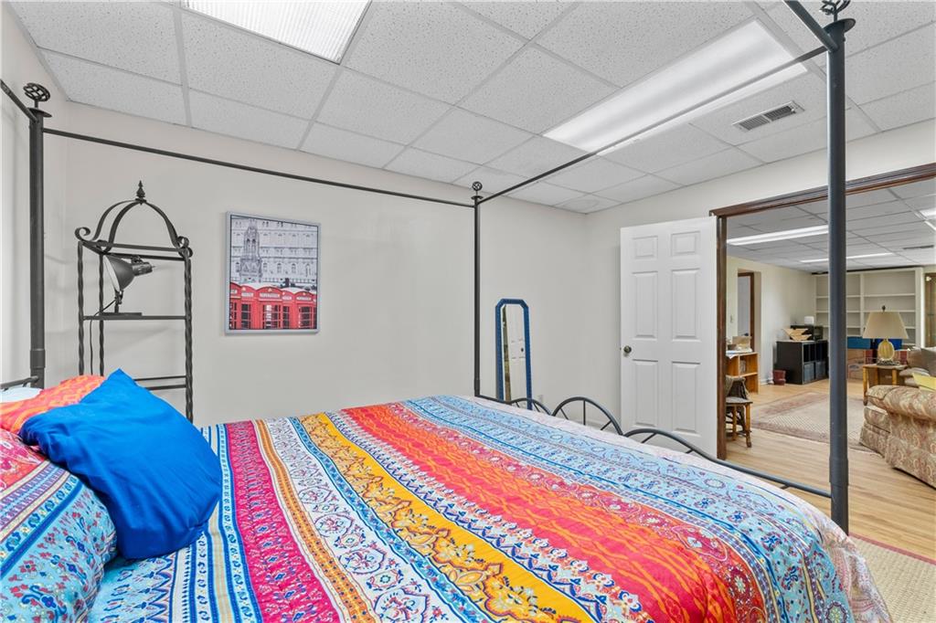 511 Oakdale Road Canton, GA 30114 - Photo 28 of 50 a bedroom with a bed and a painting on the wall