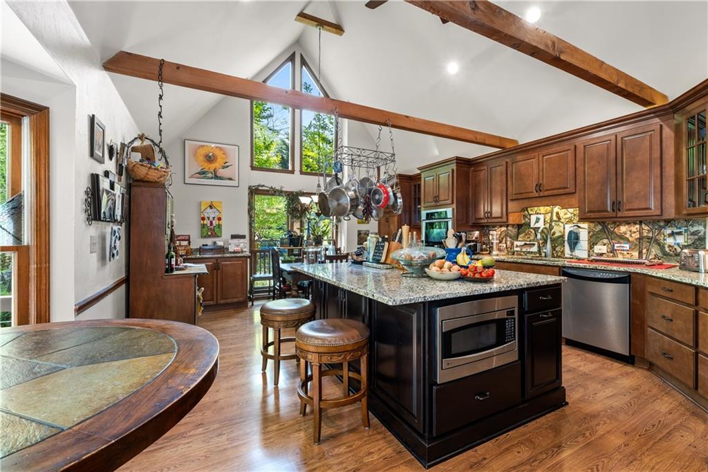 511 Oakdale Road Canton, GA 30114 - Photo 3 of 50 a kitchen with stainless steel appliances granite countertop a sink a stove and a wooden floors