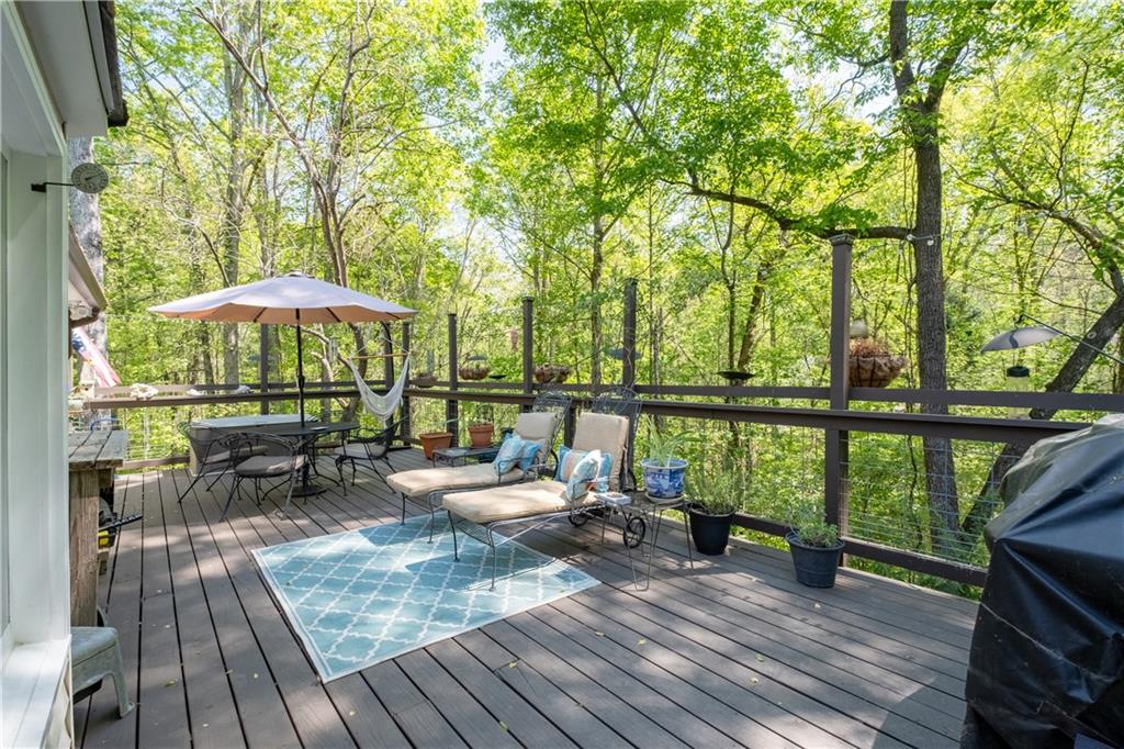 511 Oakdale Road Canton, GA 30114 - Photo 40 of 50 a view of a deck with chairs and wooden floor