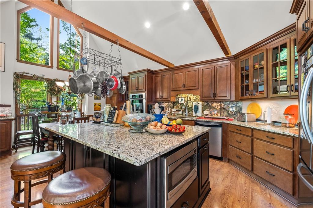 511 Oakdale Road Canton, GA 30114 - Photo 4 of 50 a kitchen with stainless steel appliances granite countertop a sink a stove and a wooden floors