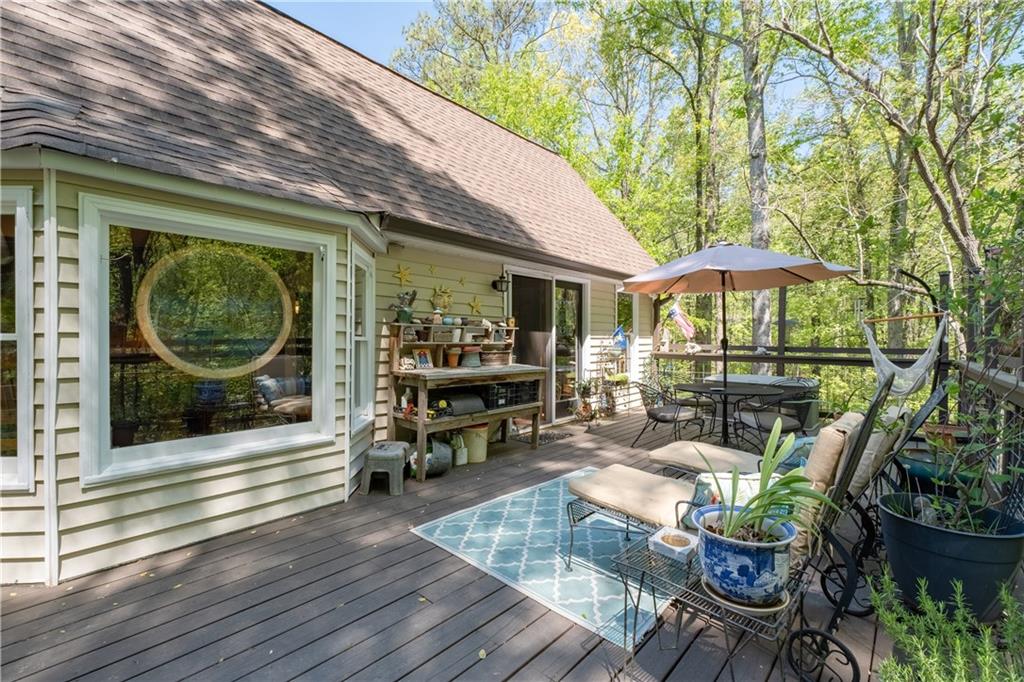511 Oakdale Road Canton, GA 30114 - Photo 41 of 50 a view of a patio with table and chairs potted plants with wooden floor
