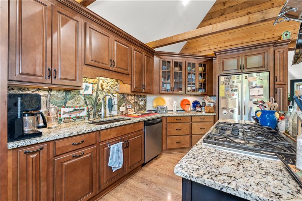 511 Oakdale Road Canton, GA 30114 - Photo 6 of 50 a kitchen with stainless steel appliances granite countertop a sink stove and cabinets