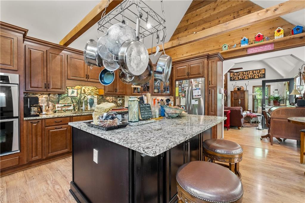 511 Oakdale Road Canton, GA 30114 - Photo 8 of 50 a kitchen with stainless steel appliances granite countertop a sink a counter space and wooden floor