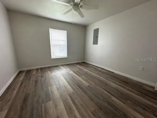 wooden floor in an empty room with a window