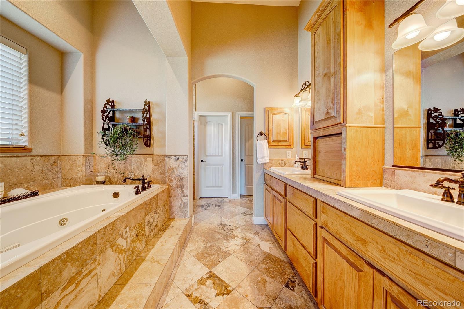 37053 Soaring Eagle Circle Severance, CO 80550 - Photo 19 of 35 a spacious bathroom with a tub sink and mirror