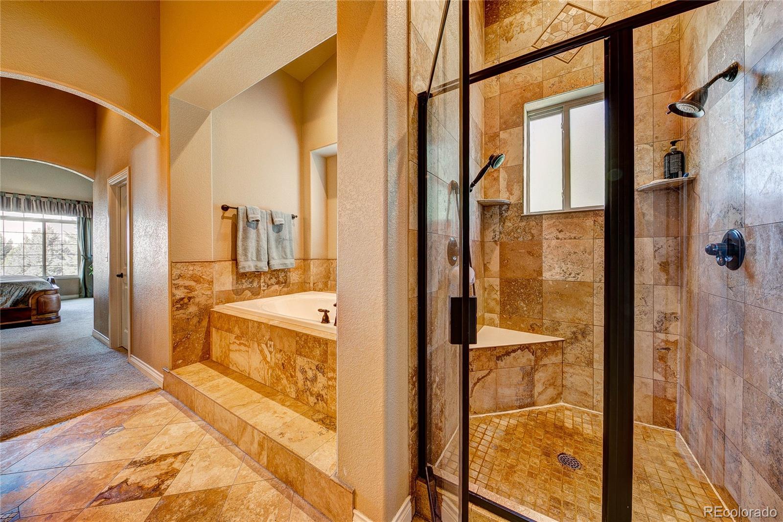 37053 Soaring Eagle Circle Severance, CO 80550 - Photo 20 of 35 a large bathroom with a tub and shower