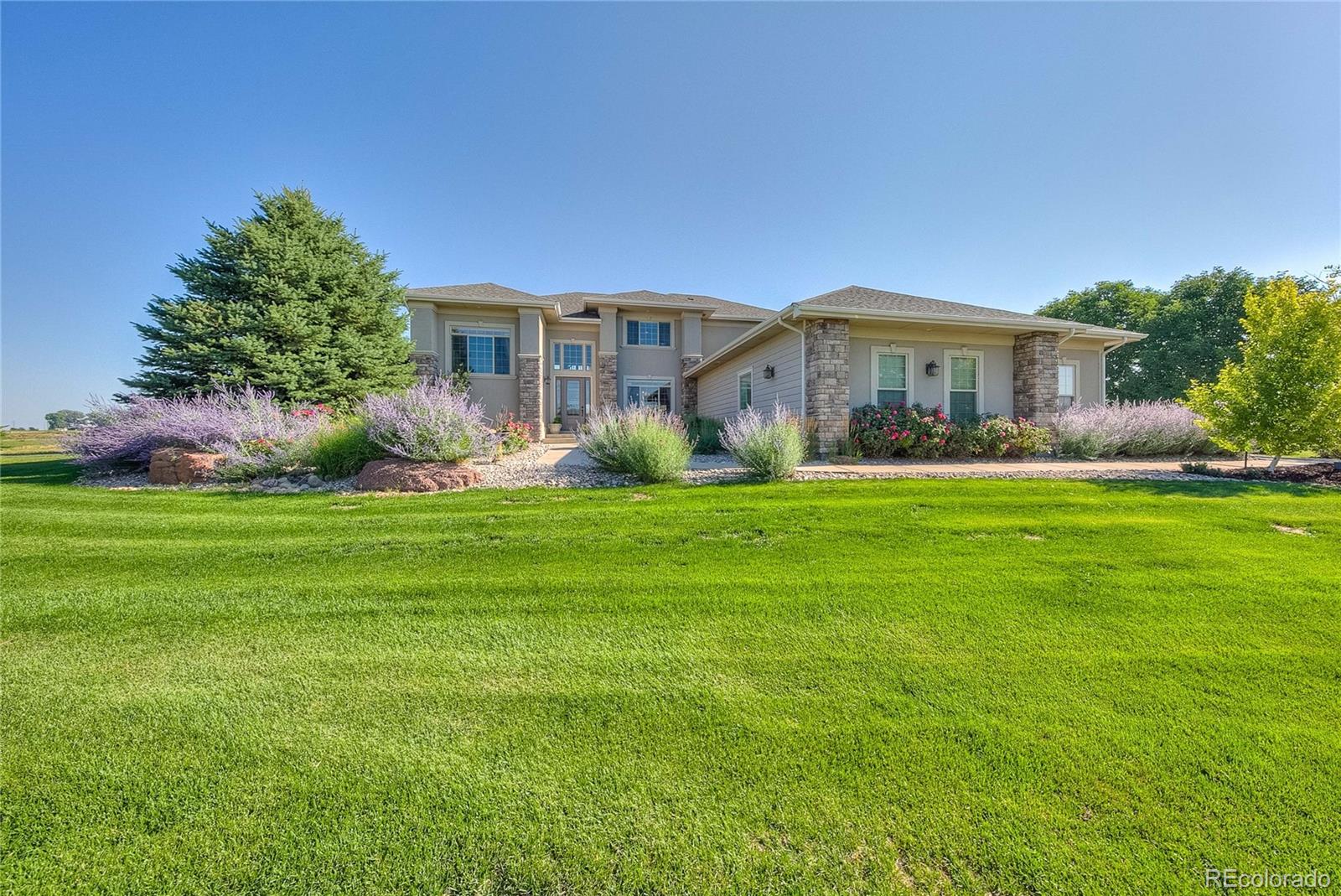 37053 Soaring Eagle Circle Severance, CO 80550 - Photo 2 of 35 a front view of a house with garden and trees