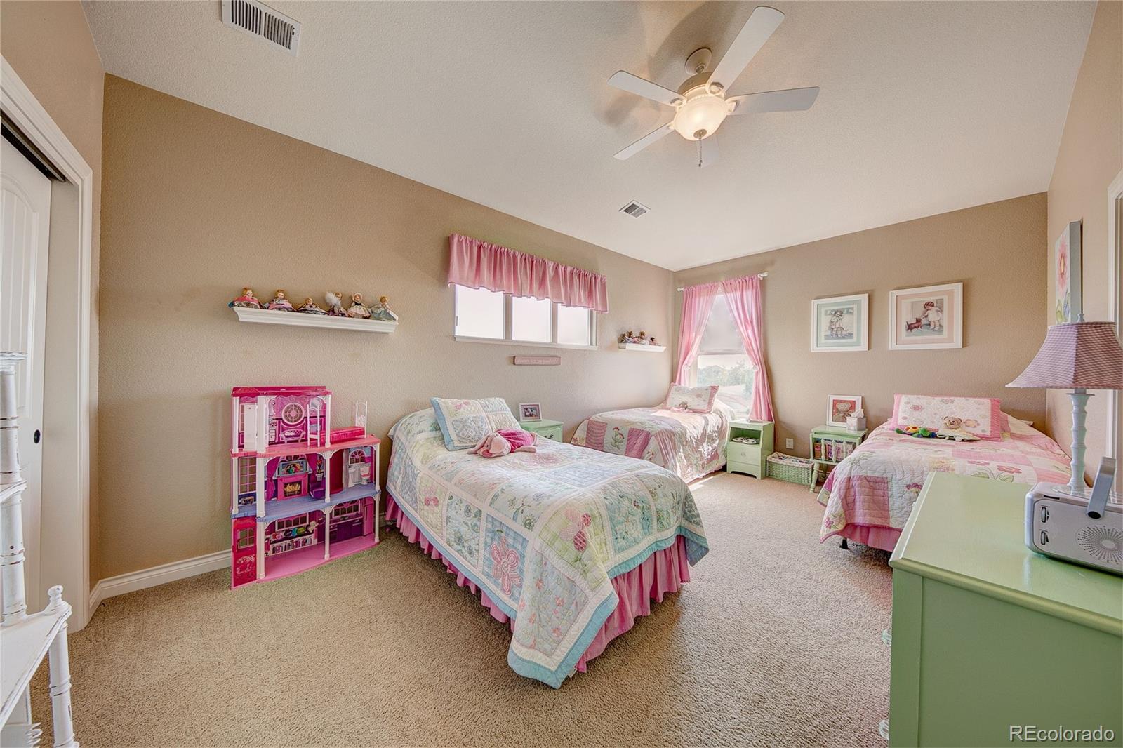 37053 Soaring Eagle Circle Severance, CO 80550 - Photo 25 of 35 a bedroom with a bed and a chandelier