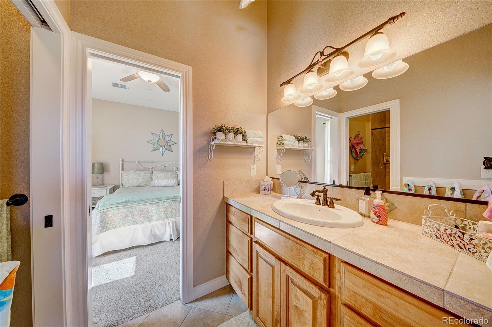 37053 Soaring Eagle Circle Severance, CO 80550 - Photo 26 of 35 a bathroom with a sink double vanity and a mirror
