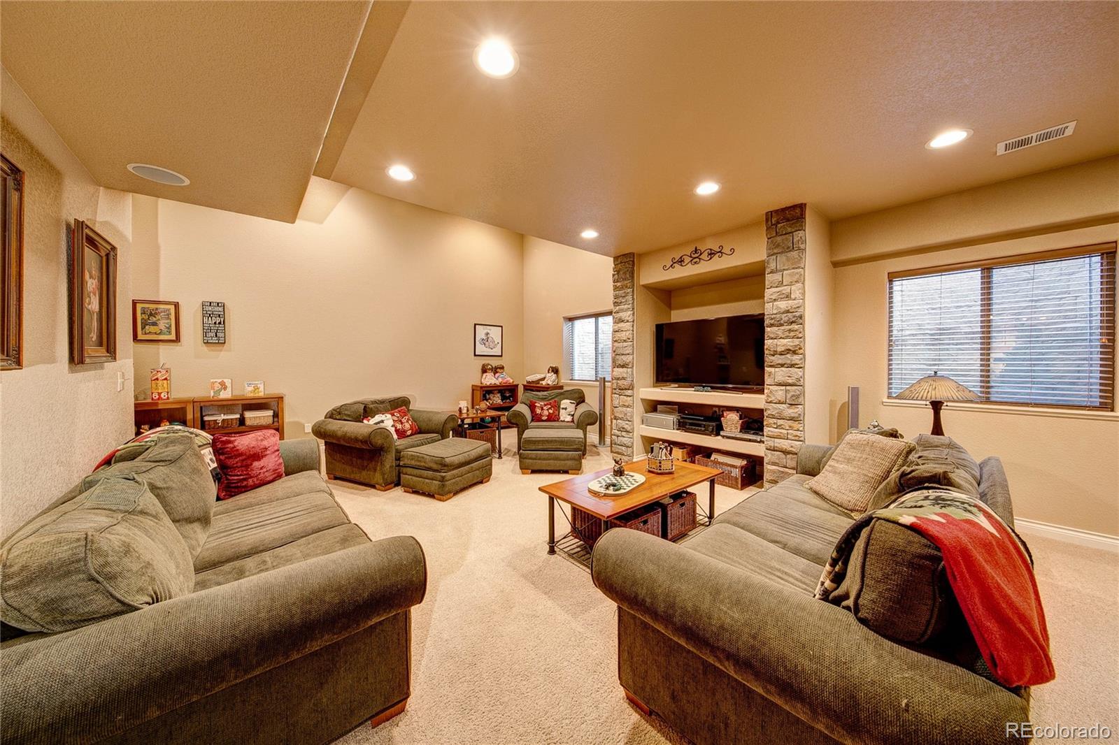 37053 Soaring Eagle Circle Severance, CO 80550 - Photo 29 of 35 a living room with furniture and a flat screen tv