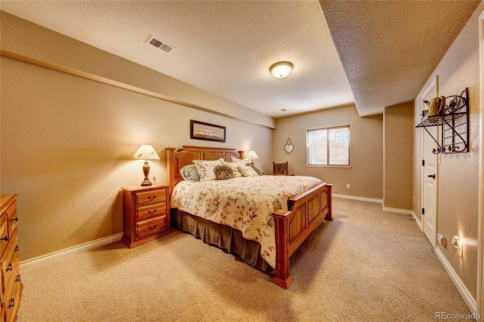 37053 Soaring Eagle Circle Severance, CO 80550 - Photo 32 of 35 a bedroom with a bed lamp closet and window