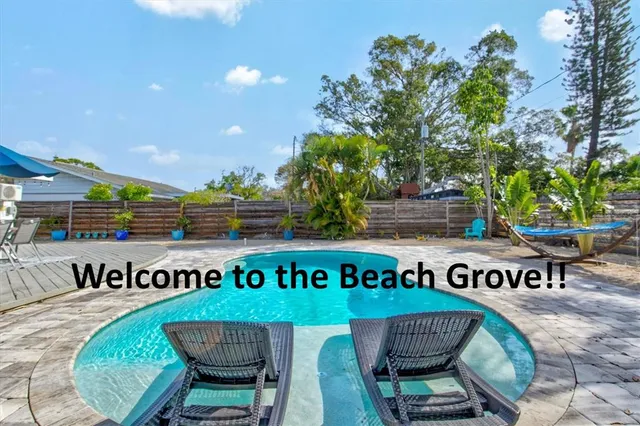 a view of a house with backyard and sitting area
