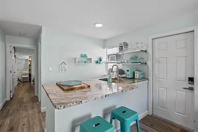 a kitchen with a sink cabinets and window