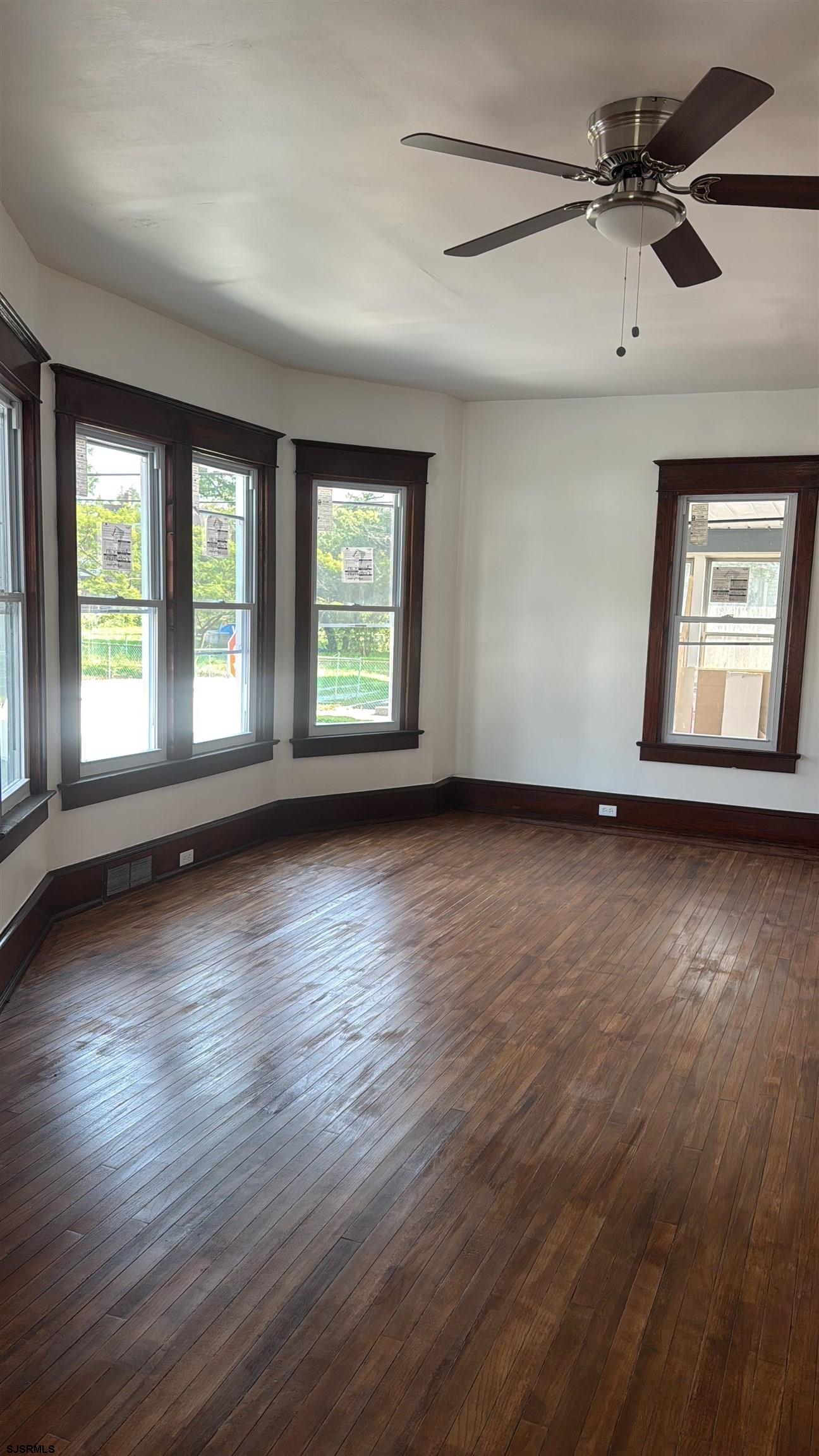 87 West Pitman Street Penns Grove, NJ 08069 - Photo 2 of 9 a view of an empty room with wooden floor and a window