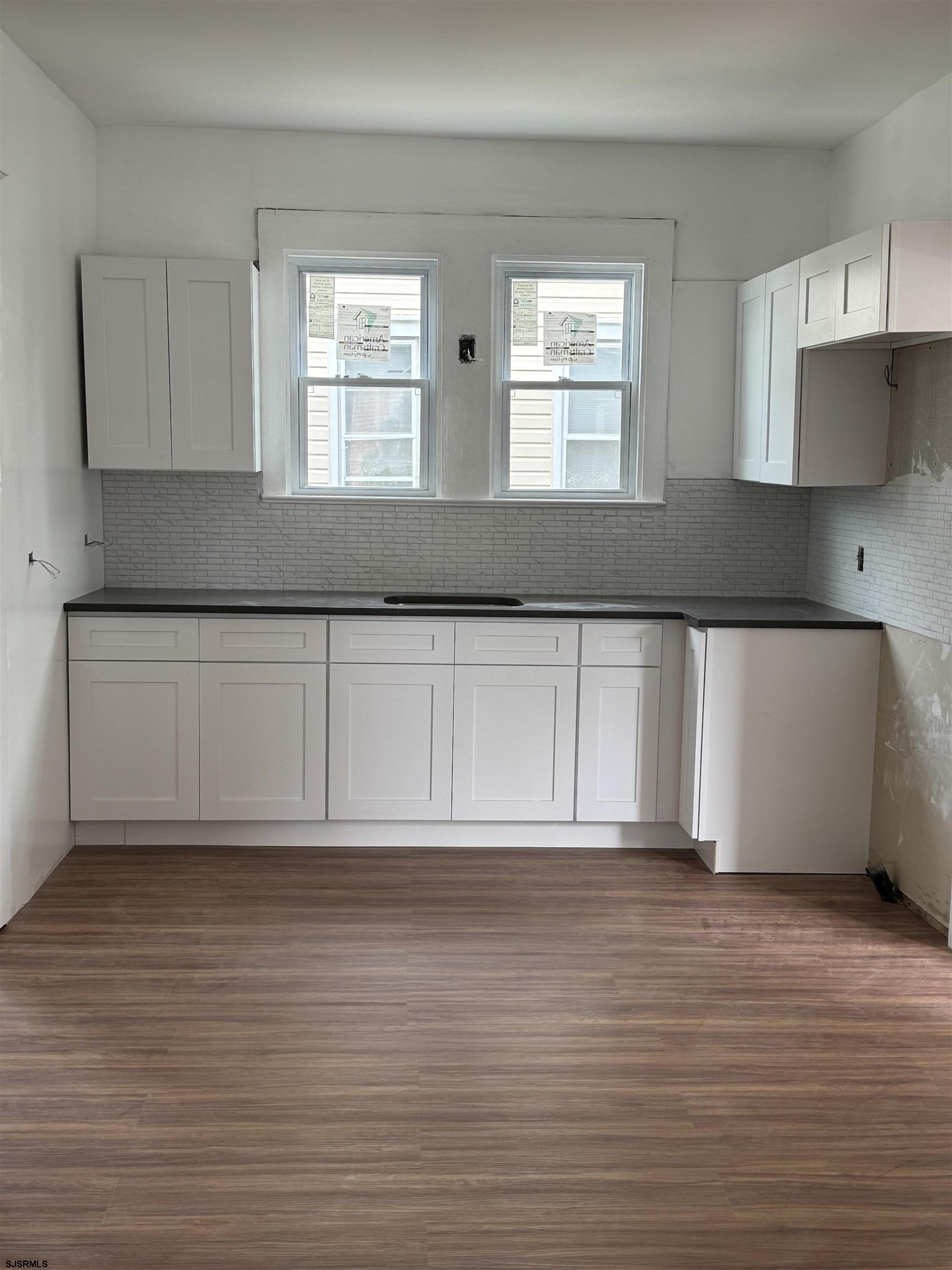 87 West Pitman Street Penns Grove, NJ 08069 - Photo 3 of 9 a view of an empty room with wooden floor and a window