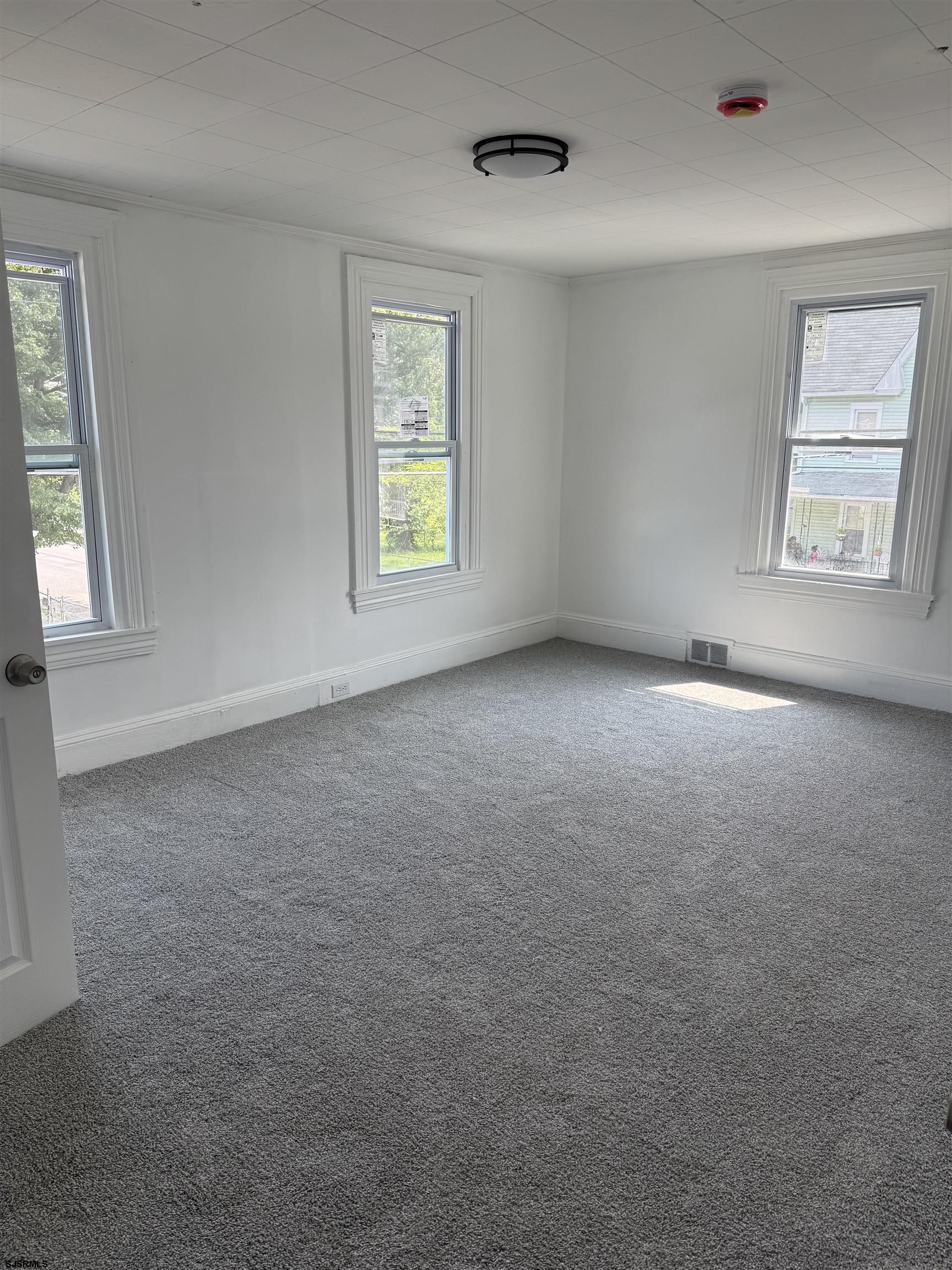 87 West Pitman Street Penns Grove, NJ 08069 - Photo 5 of 9 an empty room with windows and window