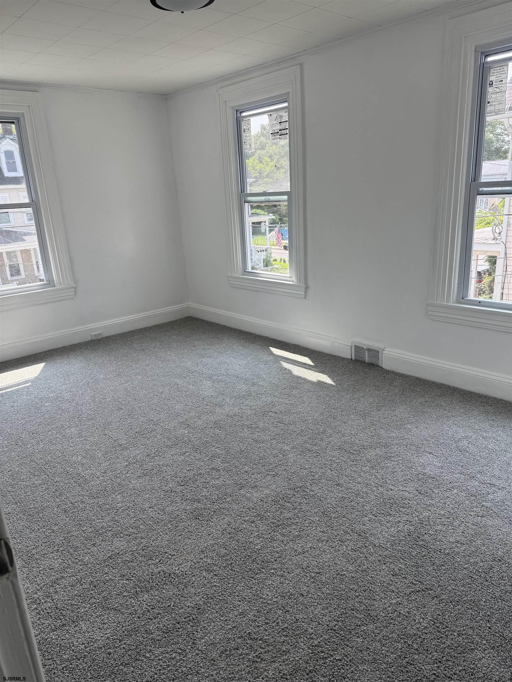 87 West Pitman Street Penns Grove, NJ 08069 - Photo 7 of 9 an empty room with windows