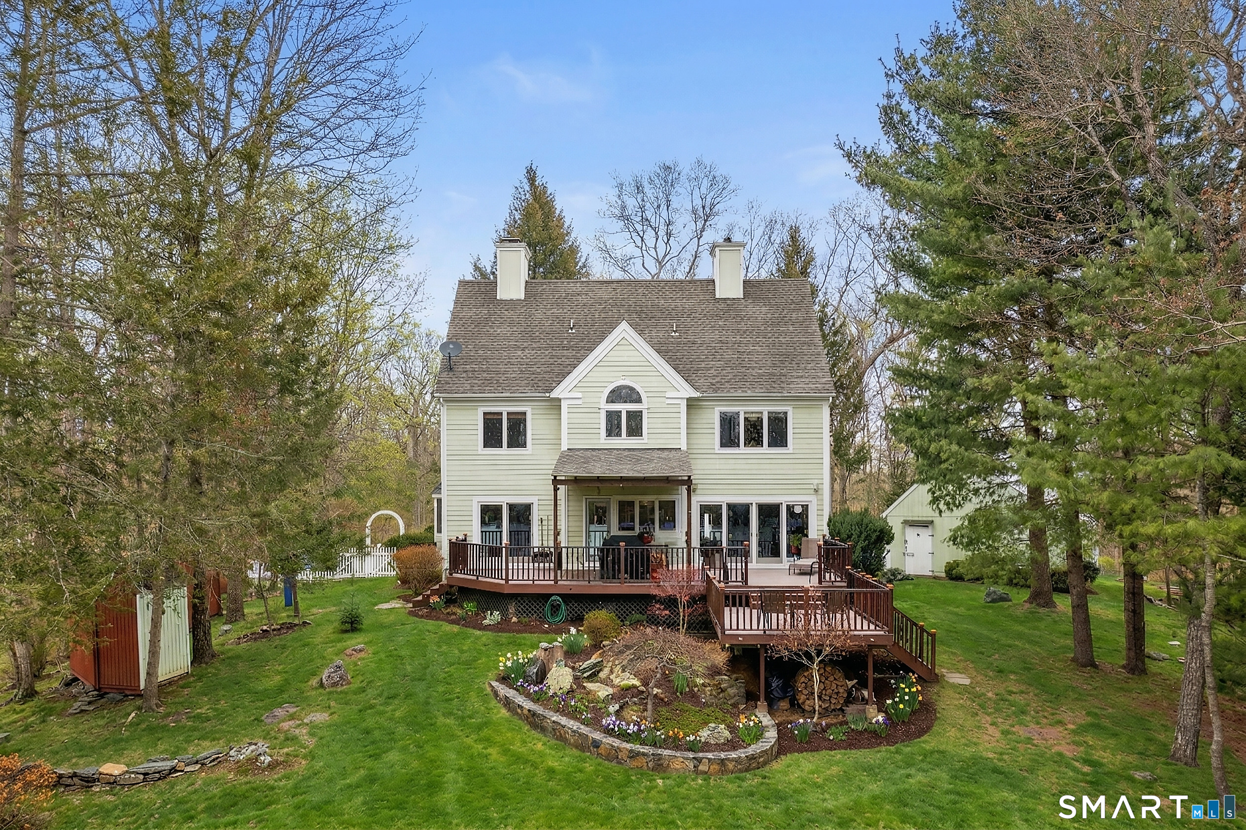 9 A Obtuse Rocks Road Brookfield, CT 06804 - Photo 27 of 36 a view of a house with garden and trees in the background