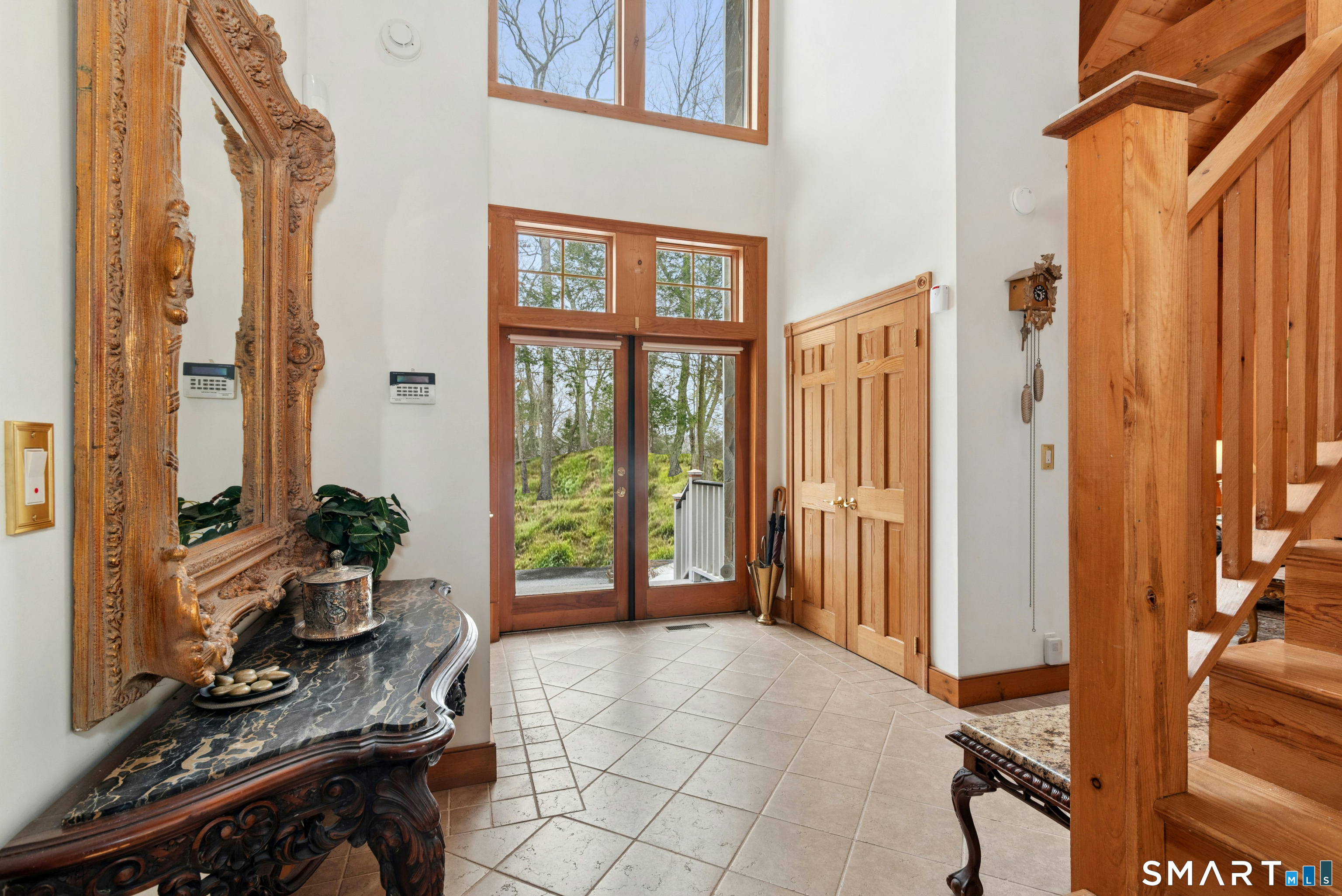 9 A Obtuse Rocks Road Brookfield, CT 06804 - Photo 5 of 36 a hallway with a dining table and chairs