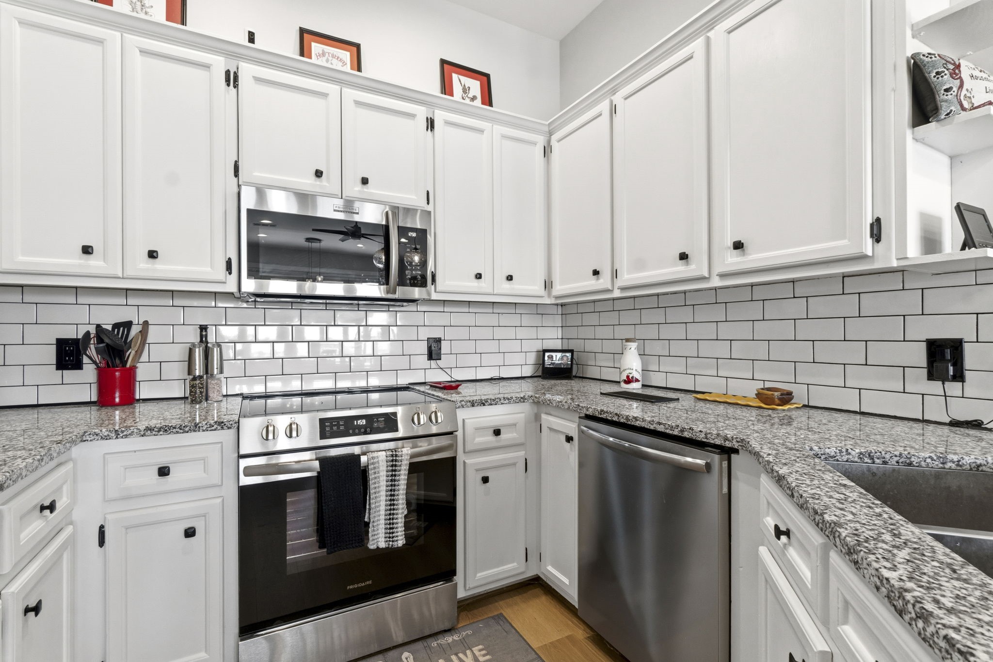 2 Key Harbour Conroe, TX 77356 - Photo 14 of 41 a kitchen with stainless steel appliances granite countertop a stove a sink and white cabinets