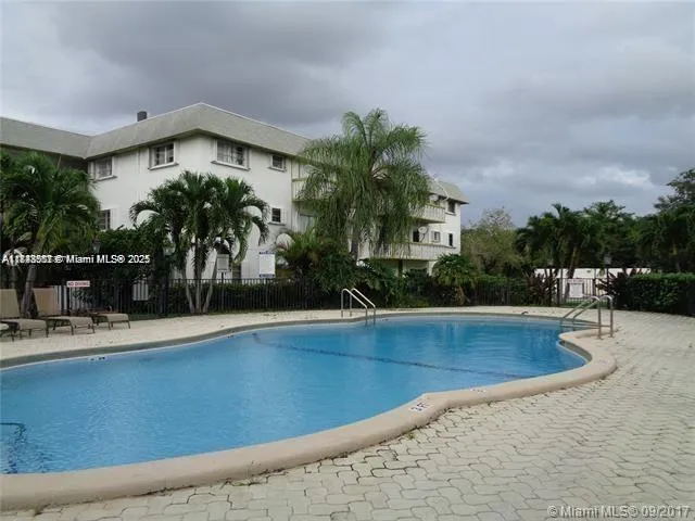a view of a house with pool and sitting area