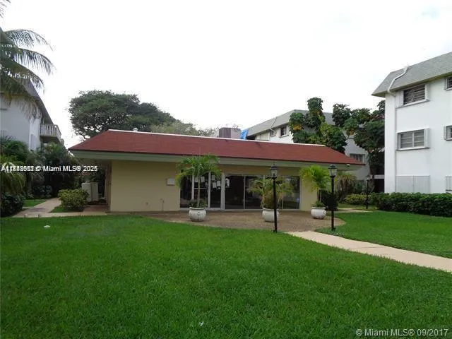 a view of a house with a yard and sitting area