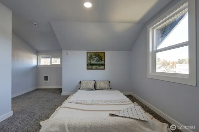 a bedroom with a bed and window