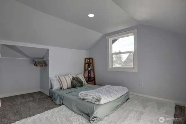 a bedroom with a bed and window
