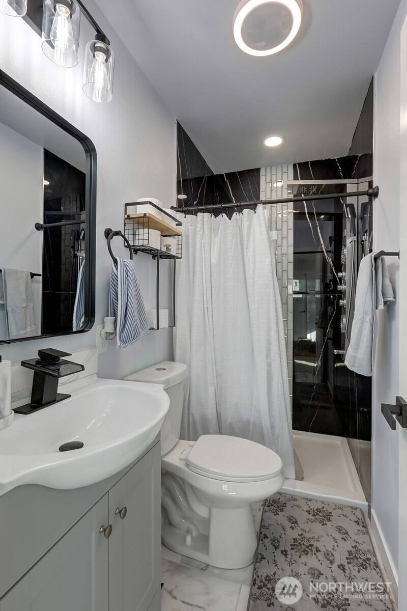 3217 South Durango Street Tacoma, WA 98409 - Photo 18 of 21 a bathroom with a sink toilet and shower