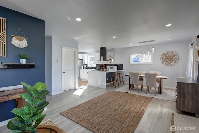 a living room with furniture and a kitchen