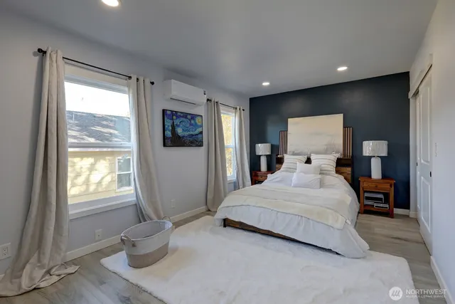 a bedroom with a large bed and a window