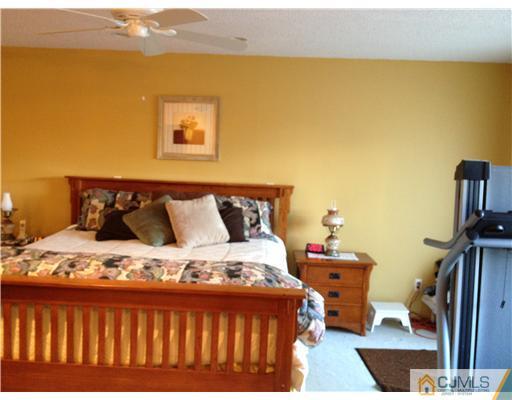 3 Westgate Drive Edison, NJ 08820 - Photo 12 of 14 a bed sitting in a bedroom next to a lamp