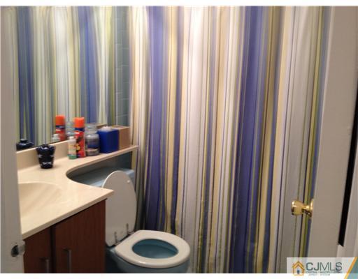 3 Westgate Drive Edison, NJ 08820 - Photo 13 of 14 a bathroom with a granite countertop sink and a mirror