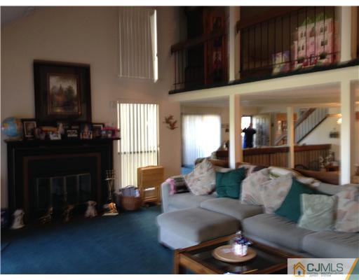 3 Westgate Drive Edison, NJ 08820 - Photo 6 of 14 a living room with furniture and a fireplace