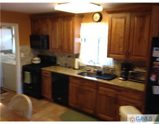 3 Westgate Drive Edison, NJ 08820 - Photo 7 of 14 a kitchen with a sink and cabinets