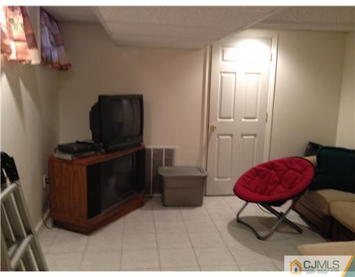 3 Westgate Drive Edison, NJ 08820 - Photo 10 of 14 a living room with furniture and a flat screen tv