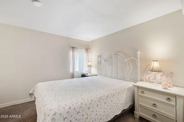 a bedroom with a bed and a dresser