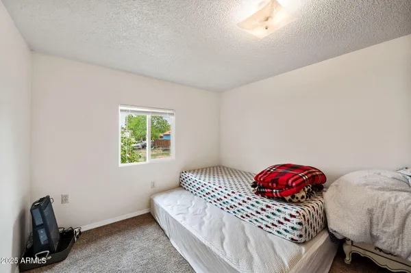 a bedroom with a bed and a window