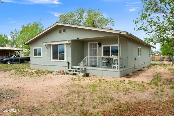 a front view of house with yard outdoor seating and yard in back